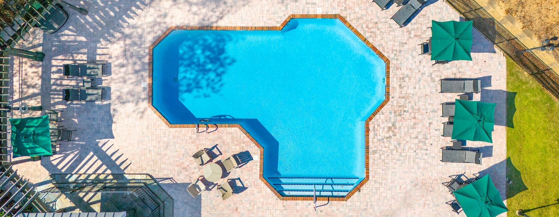 aerial view of a resort style pool with seating