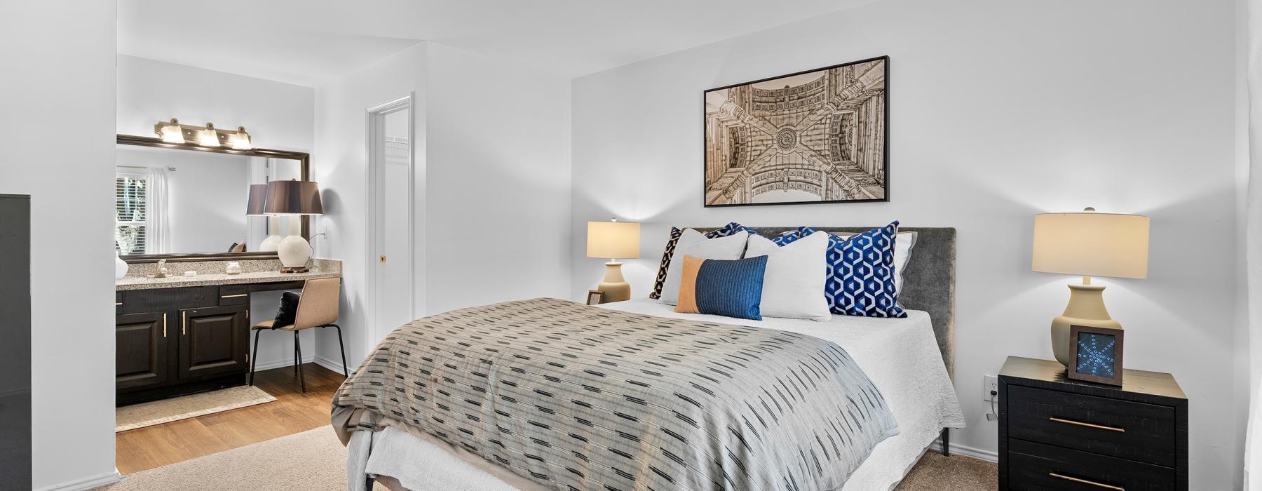 a bedroom with a bed and lamps