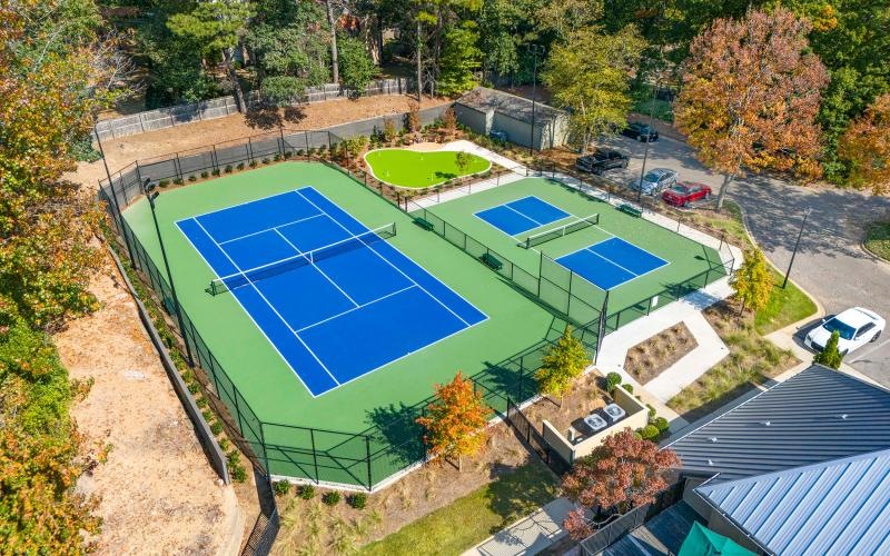 aerial view of a tennis court pickleball court putting green and clubhouse