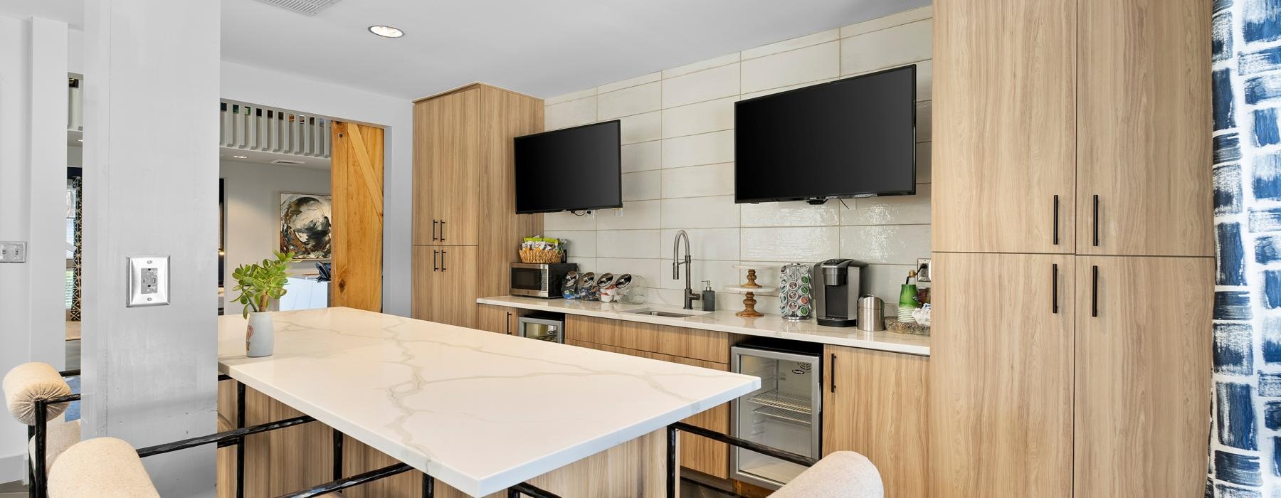 a kitchen with tvs table and chairs